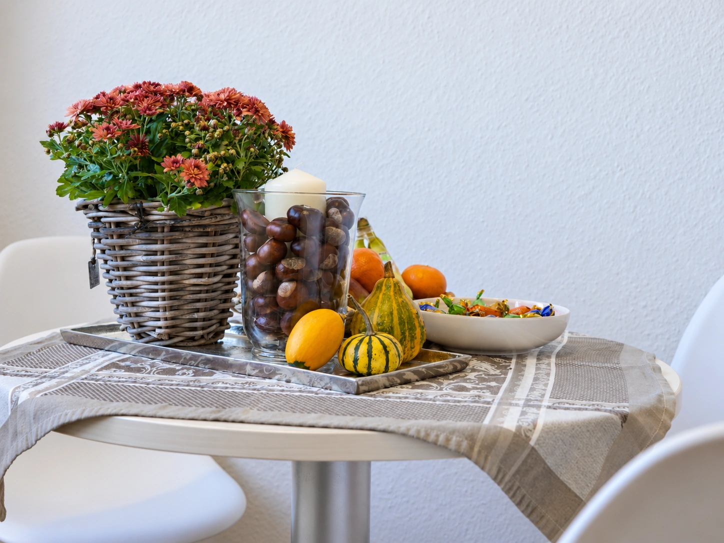 Gedeckter Tisch mit Obstschale und Blumen in einem hellen Raum